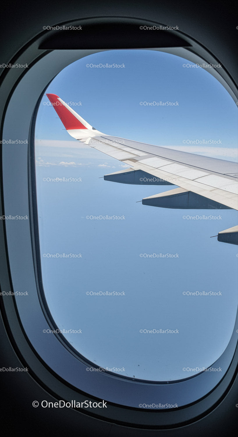 View of Airplane Wing at High Altitude from Commercial Aircraft Window
