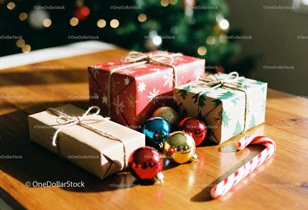 Wrapped holiday gifts with ornaments and candy cane