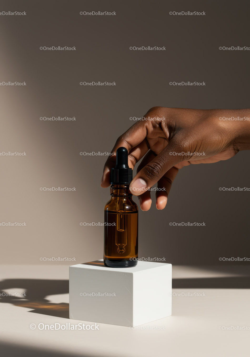 Elegant Brown Dropper Bottle with Hand Holding Aromatic Oil
