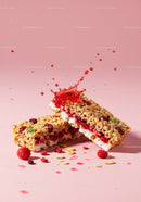Granola bars with creamy filling and red fruit splashes