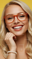 Smiling blonde woman wearing orange glasses and pearl bracelet