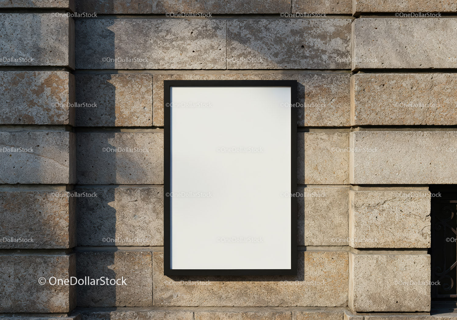 Blank poster frame on rustic stone wall outdoors