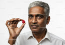 Senior Man Holding Raspberry for Healthy Lifestyle and Wellness