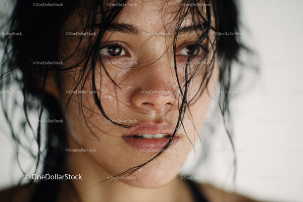 Close-up of a Woman with Wet Hair and Expressive Brown Eyes