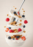 Fresh berries and granola splashing in creamy yogurt