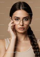 Fashionable Woman Wearing Stylish Round Glasses in Neutral Setting
