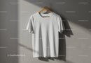 Plain white t shirt hanging on wooden hanger indoors
