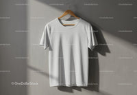 Plain white t shirt hanging on wooden hanger indoors