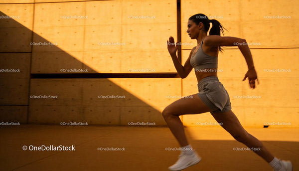 Athletic woman sprinting with powerful stride outdoors