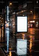 Illuminated Bus Stop Shelter on Rainy Night with Reflections