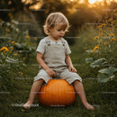 Toddler Sitting on Large Pumpkin in Autumn Garden