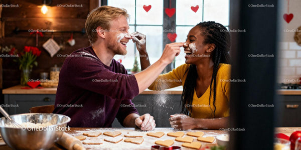 Couple playfully baking heart cookies in cozy kitchen