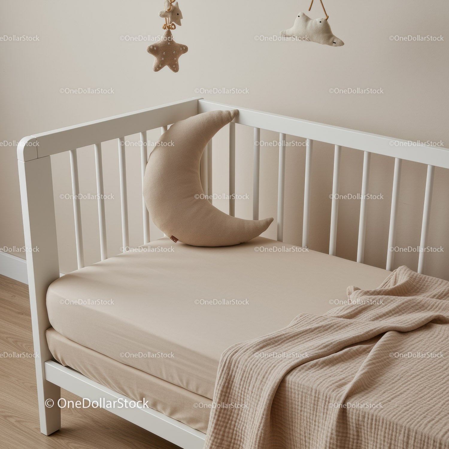 Minimalist baby crib with moon shaped pillow and toys