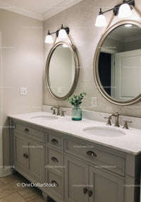 Elegant Bathroom Vanity with Oval Mirrors and Modern Lighting