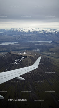 Aerial View of Snow-Capped Mountains and Volcanoes Over Fjords