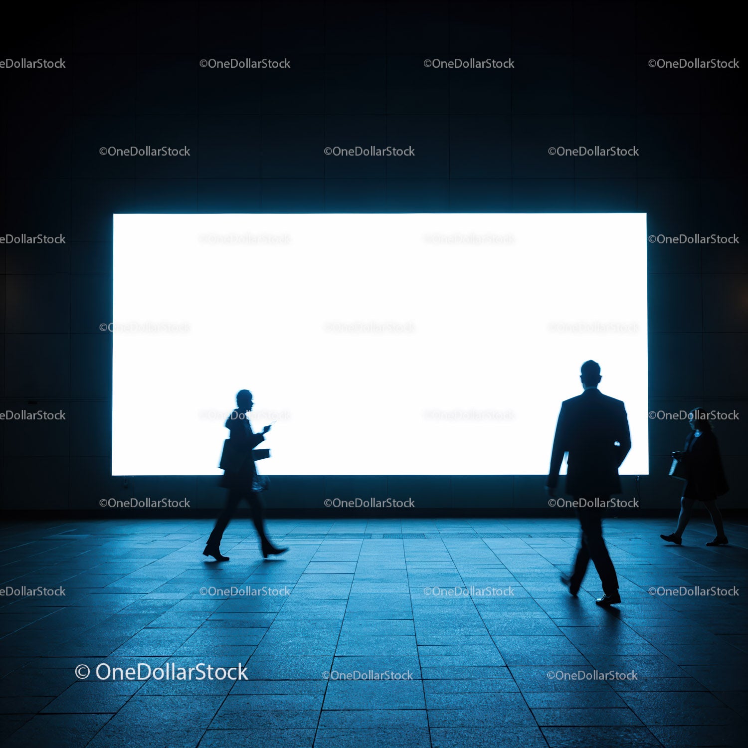 Silhouettes of business people walking by illuminated screen