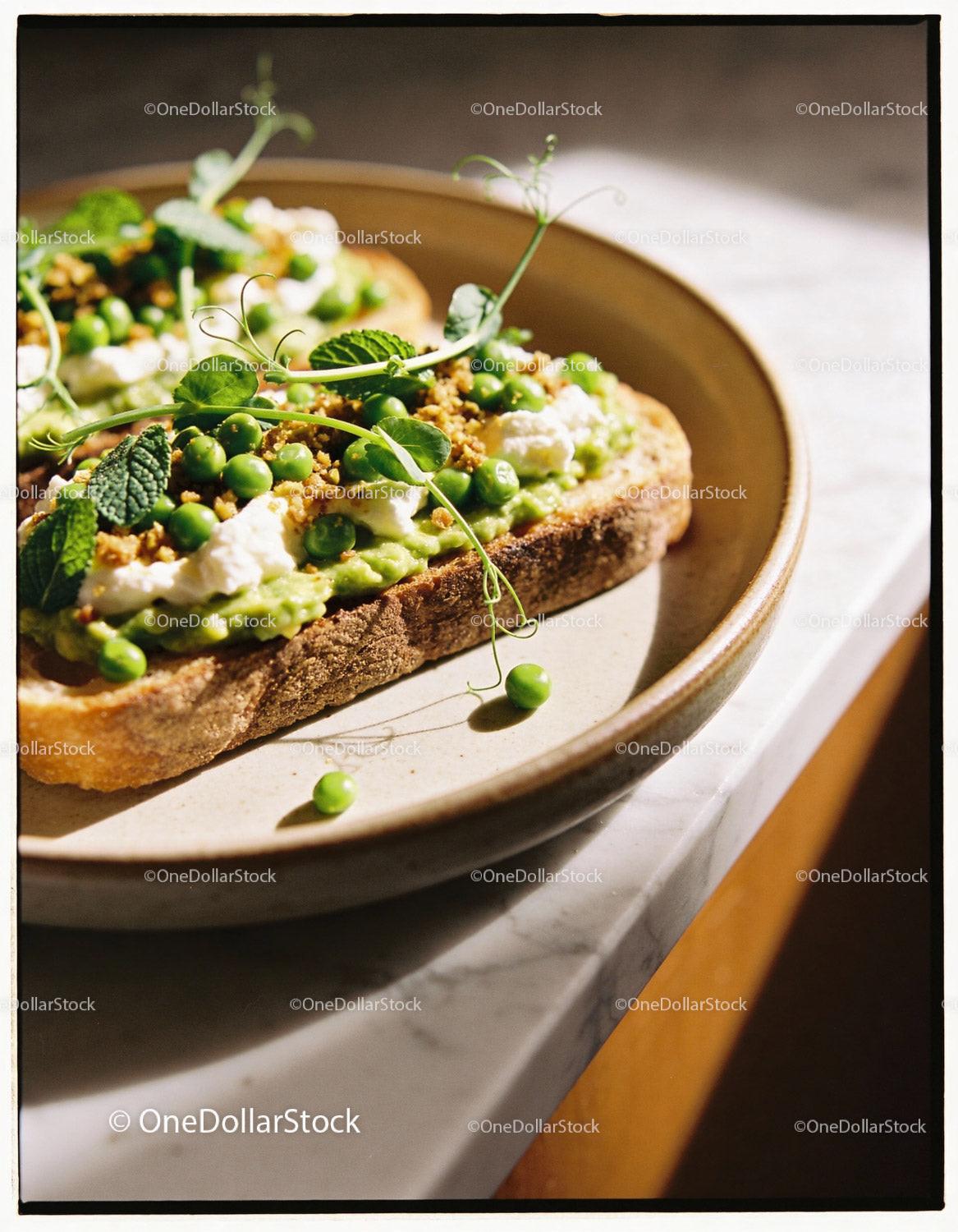 Rustic toast topped with fresh peas and ricotta cheese