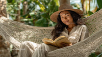 Relaxing Woman Reading in Hammock in Tropical Garden