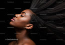Relaxed woman with flowing hair against black background