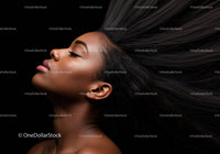 Relaxed woman with flowing hair against black background