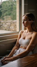 Contemplative Young Woman Sitting by Window in Indoor Cozy Atmosphere