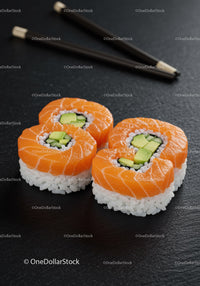 Fresh salmon sushi rolls with avocado and cucumber filling
