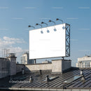 Blank urban billboard on building rooftop under clear sky