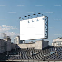 Blank urban billboard on building rooftop under clear sky