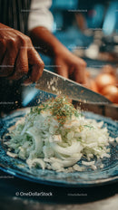 Chef Chopping Onions in a Professional Kitchen During Food Preparation