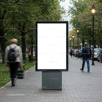 Blank urban advertising board on city sidewalk in autumn