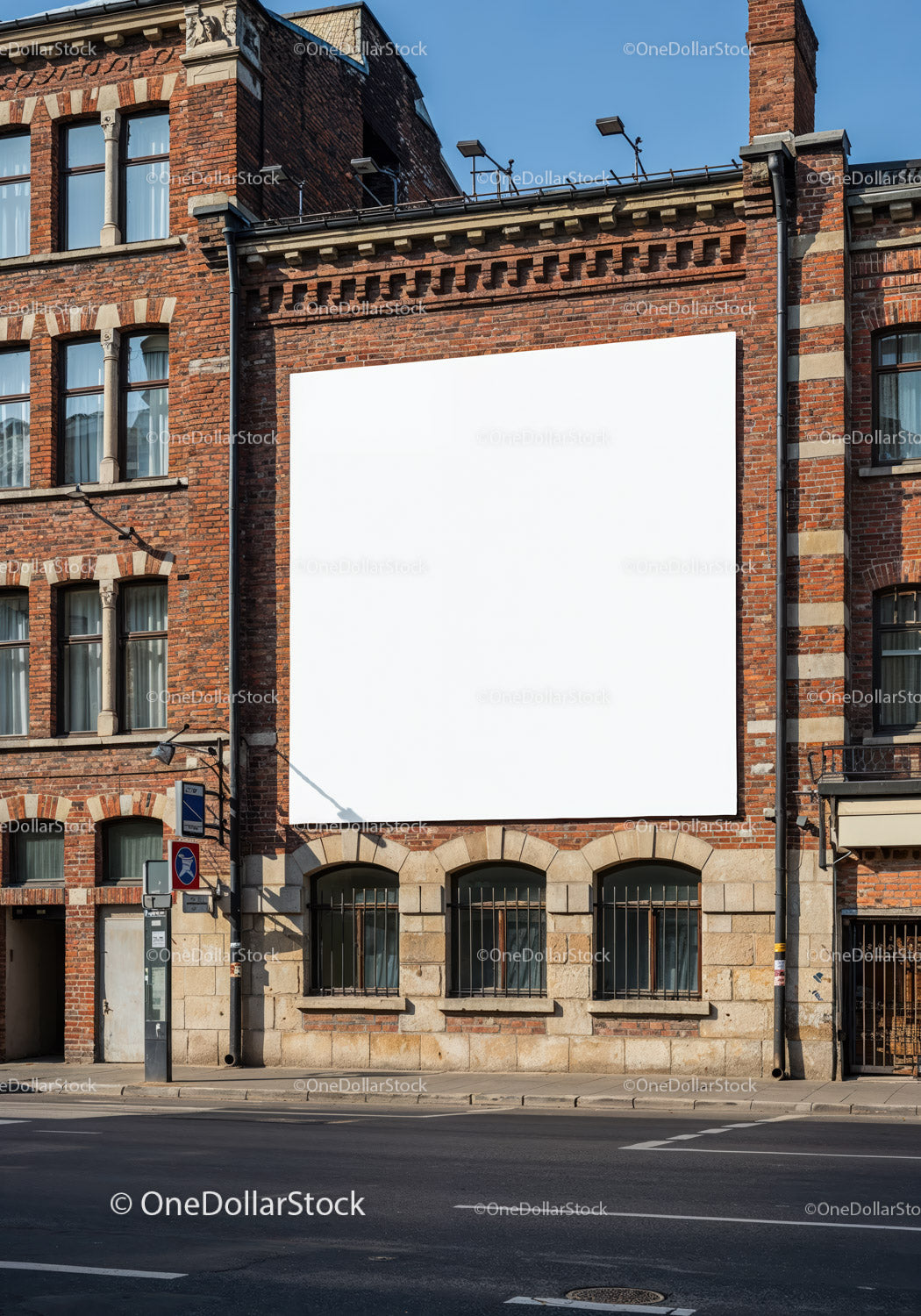 Blank white billboard on historic brick building facade