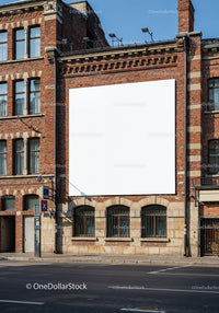 Blank white billboard on historic brick building facade
