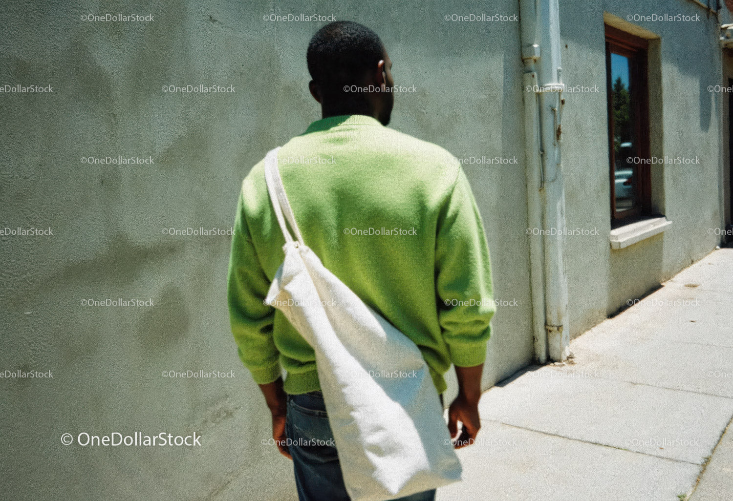Urban Street Scene with Man in Green Sweater and White Tote Bag