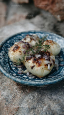 Roasted Onions with Garlic and Thyme on Decorative Plate