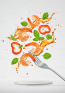 Fresh shrimp and basil with splash of sauce on fork