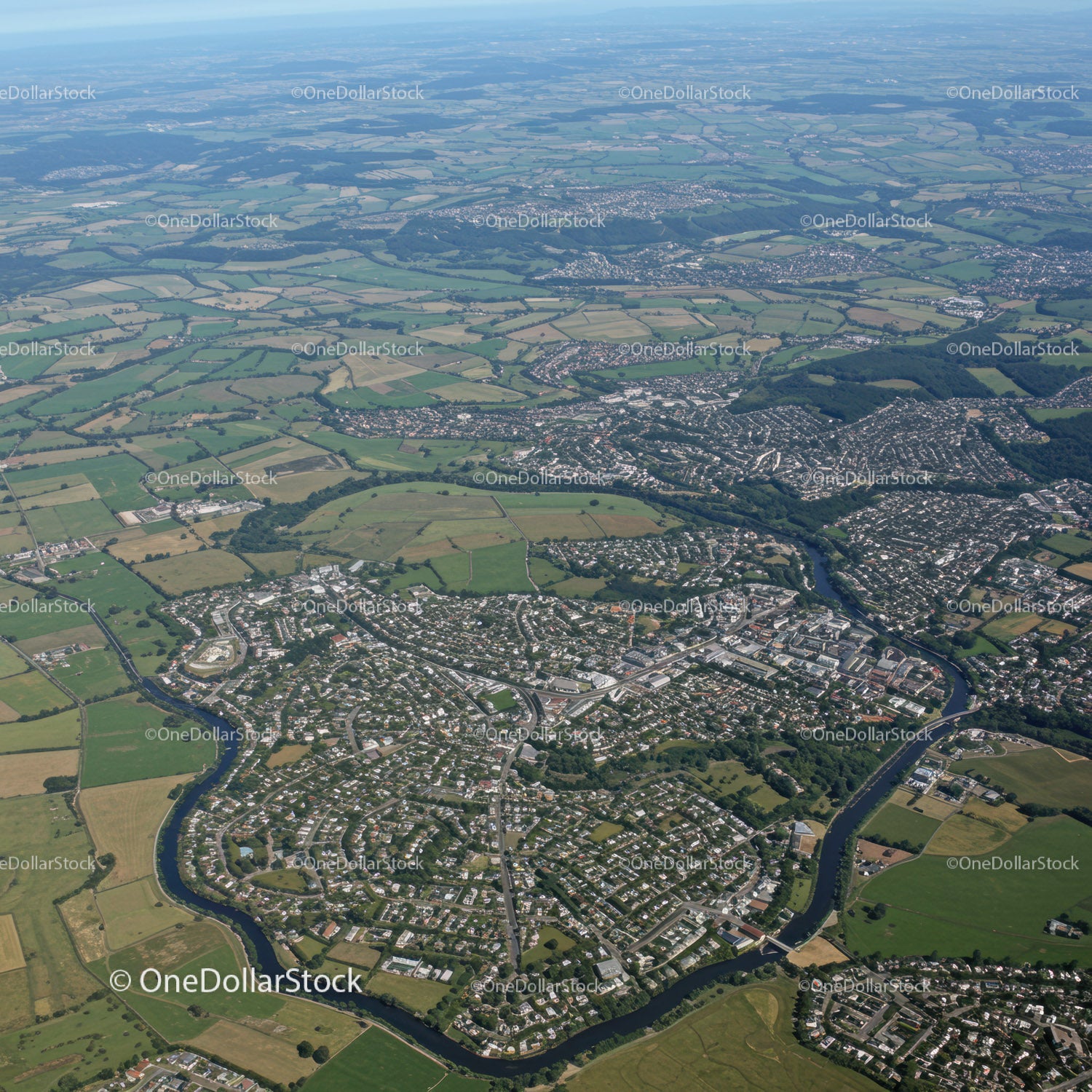 Aerial View of a Town with Green Fields and River