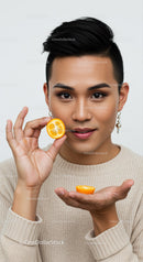 Portrait of a Young Woman Holding a Lemon Slice for Fresh Beauty