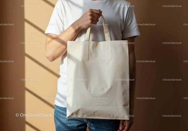 Person Holding Blank Reusable Shopping Bag in Warm Light JPG Mockup Image