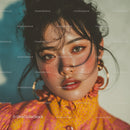 Close-Up of a Woman with Dark Hair and Golden Jewelry in Glamorous Style