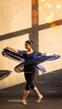 Graceful dancer spinning with flowing navy scarf