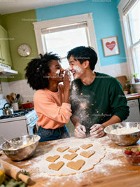 Couple Playfully Baking Heart-Shaped Cookies Together