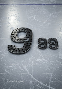 Number 9 Composed of Hockey Pucks on Ice Rink Surface