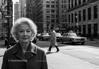 Elderly Woman Walking on City Street in Black and White Urban Scene