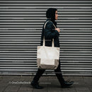 Person Walking Along Urban Metal Shutter Wall