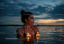 Woman in Black Bikini with Candles Floating in Lake at Sunset