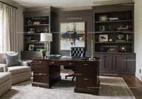 Elegant home office with dark wood desk and modern decor