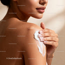 Close-up of woman applying moisturizing cream on shoulder