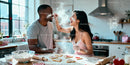 Couple Baking Heart Shaped Cookies and Laughing Together