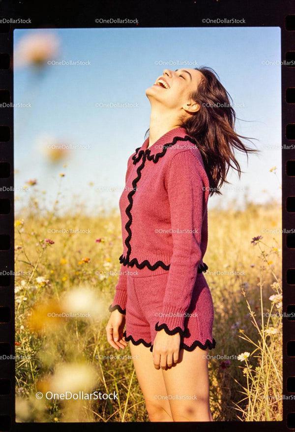 Young woman laughing joyfully in sunny wildflower field