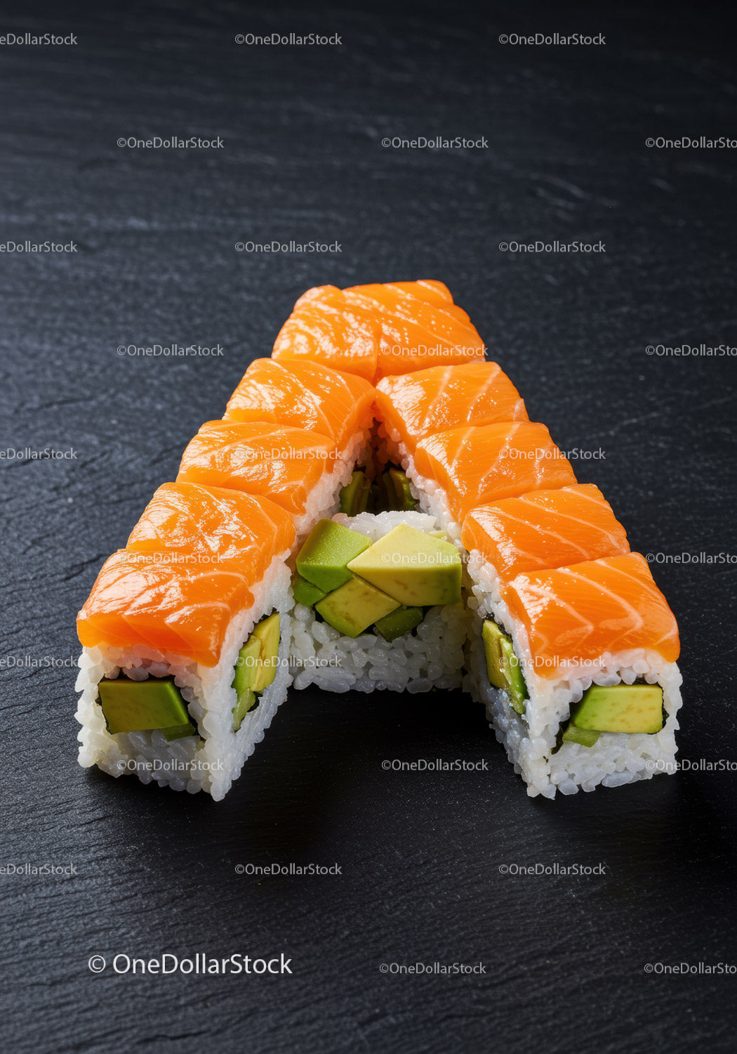 Fresh salmon and avocado sushi arranged on dark slate